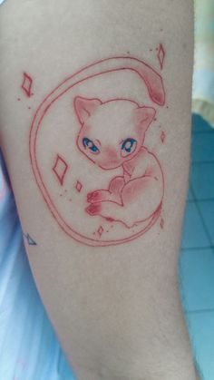 a cat with blue eyes sitting in a circle tattoo on the leg and it's arm