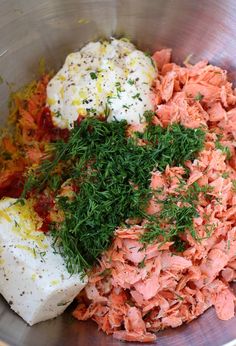 a metal bowl filled with meat and vegetables