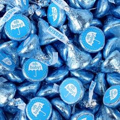 blue candy candies with the words oh baby on them are piled up in a pile