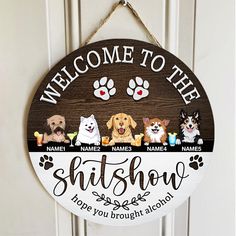 a welcome sign hanging on a door with dogs and their name written in black ink