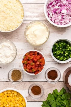 the ingredients for this mexican salad are laid out in bowls