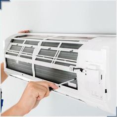 a person is adjusting the air conditioner on an air conditioner that has been installed