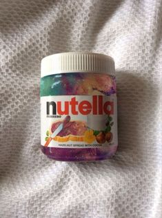 a jar of nutella is sitting on a bed