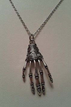 "I think it is hard to find Halloween jewelry that isn't TOO cartoony, kitchy or just plain ugly! :D   When I found these uber CREEPY skeleton hand charms I KNEW just what to do with them! LOL   I CURRENTLY ONLY HAVE A COUPLE OF THESE CHARMS IN STOCK  Grab one now before they are gone! :) Tibetan silver skeleton hand charm, suspended with stainless steel jump rings on a 18\" stainless steel link chain w/ 3\" extender chain.   I LOVE using stainless steel - it is SO sturdy, does not tarnish, is h Grunge Jewelry For Halloween Gift, Grunge Halloween Jewelry Gift, Handmade Grunge Jewelry For Halloween, Collectible Metal Jewelry For Halloween, Grunge Skull Jewelry For Gift, Hand Cast Skull Jewelry For Halloween, Punk Style Hand Cast Halloween Jewelry, Handmade Grunge Halloween Jewelry, Gothic Halloween Necklaces With Adjustable Chain