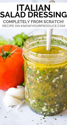 a jar filled with pesto sauce next to vegetables