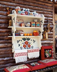 a wooden wall with shelves filled with decorative items and decorations on it's sides