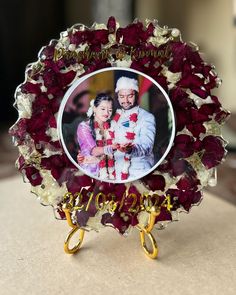 a photo frame with flowers on it sitting on a table