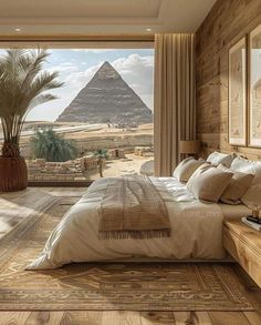 a bedroom with a large bed and a view of the pyramids