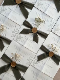 the wedding stationery is laid out on top of each other with ribbons and flowers