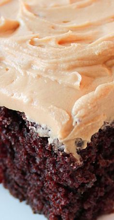 a close up of a piece of cake on a plate with frosted icing