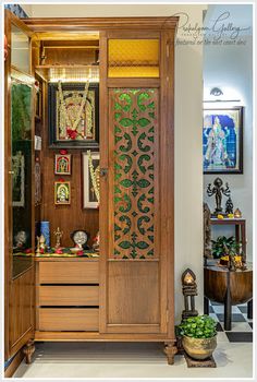 an ornate wooden armoire in a room with pictures and other items on the wall