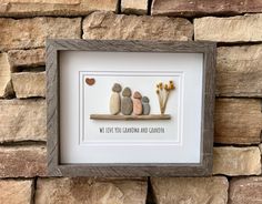 some rocks and flowers are arranged on a shelf