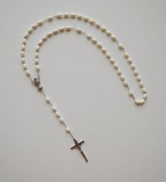 Italian made rosary for First Communion. LENGTH: 18" COLOR: White MATERIAL: Moulded Plastic. BEADS: Oval white beads CRUCIFIX: Wood crucifix measures 1-3/8" x 7/8" ALL LINKS HAVE BEEN CHECK ONE BY ONE BEFORE SHIPPING THIS ROSARY...HOWEVER IT HAS NOT BEEN DESIGNED TO USE AS A NECKLACE ROSARY AND YOU SHOULD INSTEAD USE CORD ROSARIES FOR THIS PURPOSE. HOWEVER IF YOU DECIDE TO USE IT AS A NECKLACE ROSARY WE WILL NOT BE RESPONSIBLE FOR ANY DAMAGE AND WE DON'T RECOMMEND IT This is a very good quality and elegant rosary that you can be proud to show to your friends and family. To prevent from getting damaged it's a good idea to preserve your rosary to put it in case or any container when not being used. Come Visit Us at Our New Store! Please feel free to email me with questions about this item. A Make Happy, Plastic Molds, Holy Communion, Plastic Beads, Be Proud, First Communion, White Beads, White Material, Rosary