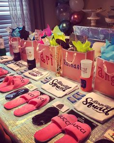 pink flip flops are lined up on a table with personalized t - shirts