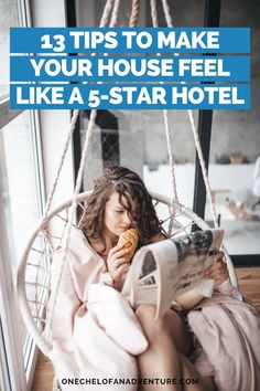 a woman sitting in a hammock reading a newspaper and eating a donut