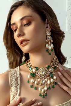 22kt gold plated pendant necklace with hydro polkis, kundan, green jades embellishment and white pearl drops. Comes with earrings.
Type: Polki, Jade, Pearl, Kundan
Composition: Brass
Color: Gold
Other Details: 
Dimensions L x W x H (in cms): 
Necklace: 38 x 4 x 1
Earrings: 9 x 3 x 1
Weight (in gms):
Necklace: 133
Earrings: 42
Set: 175
Closure:
Necklace: Pull out drawcord
Earrings: Push back clasp
Note: Mathapatti worn by the model is not for sale - Aza Fashions Green Polki Jewellery, Luxury Kundan Earrings For Party, Luxury Kundan Necklace With Intricate Design For Festivals, Luxury Traditional Kundan Necklace For Celebration, Luxury Elegant Kundan Necklace, Luxury Fusion Kundan Earrings, Telugu Jewellery, Jewellery Shoot, Bridal Necklace Designs