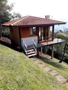 a small house with stairs leading up to it