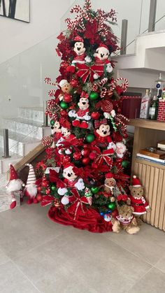 a red christmas tree with mickey mouse decorations