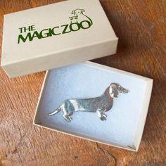 "This pewter dachshund brooch is a classic The Magic Zoo design! It has been a customer favorite for many years, and I do understand why. It has personality. It is pretty. And it is affordable. And I've been told over and over by dachshund owners that it really, actually looks like a doxie! It measures 1/4\" tall and is 2 3/4\" long. So it is a nice size. And it goes so well with the matching earrings! By the way, if you are a dachshund lover I think you'll enjoy my dachshund section in my etsy Silver Dachshund, Wired Hair Dachshund, Mid-century Cabochon Brooch Gift, Zoo Logo, Dachshund Stationery, Dachshund Jewelry, Pewter Jewelry, Yorkie Lovers, Dog Jewelry