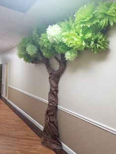 a paper tree on the wall in an office