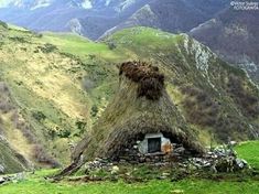 an old thatched hut in the mountains