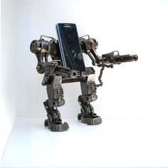 Robot Phone holder metal model is made from scrap/recycled metal and auto parts. This model is 100% hand-made by expertised Thai craftsman.  This sculpture is very solid and not easy to break because they are welded piece by piece by our professional Thai welders.  Moreover , this statue is protected by  special coating ( clear lacquer ) which keeps these unique sculptures attractive for years. This price only the metal holder ( no phone ) Sculpture stands on itself    This is made in Thailand a Graduation Gifts For Boys, Cool Name, Recycled Robot, Scrap Recycling, Sculpture Stand, Christmas Gift For Him, Name Card Holder, Unique Sculptures, Best Dad Gifts