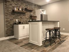 a basement bar with stools and shelves