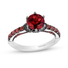 a red diamond ring with black diamonds on the band and an accent stone in the center