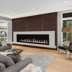 a living room with a large fireplace in the center and two couches around it