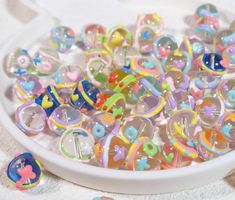 a bowl filled with lots of different colored beads