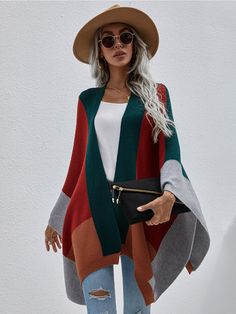 Master the art of mod layering with this cozy knit poncho that flaunts oversize kimono sleeves and a bold color block print. Size Guide: Melina is 5’6” tall, and has a 33.5” bust, 24.8”waist, & 37.4” hips. She is wearing a S / US 4 / AU 8. This poncho is true to size. Material: 50% viscose / 30% polyamide / 20% polyester Feature: Color block poncho. Oversize for comfort fitting. Care Instructions: Machine wash / Cold hand wash Costume Africain, Loose Knit Cardigan, Women Long Cardigan, Cardigan Oversized, Sleeveless Outfit, Women Shawl, Handkerchief Hem, Loose Knit, Loose Tops