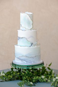 a white wedding cake sitting on top of a table