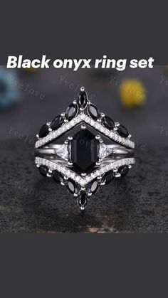 a black and white diamond ring on top of a table