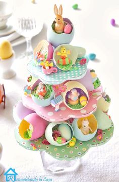 there is a small tree made out of eggs and other items on the table in front of it