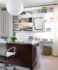 an office with a desk, chair and bookshelf