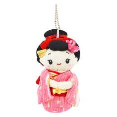 a small stuffed doll hanging from a chain