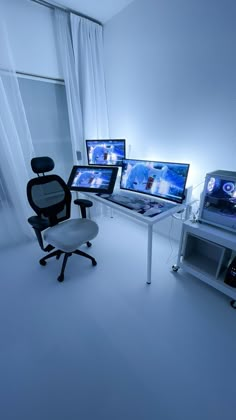 there are three computer monitors on the desk