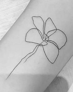 a single line flower tattoo on the arm