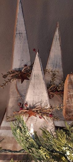 three wooden christmas trees on top of a table