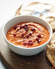 there is a bowl of soup and crackers on the plate