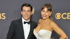 a man and woman posing on the red carpet at an awards event for outstanding performance