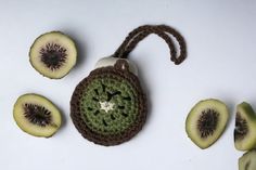 a crocheted bag with kiwi slices around it on a white table top