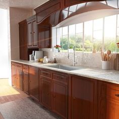 an empty kitchen with wooden cabinets and white counter tops is pictured in this image, the sun shines through the windows