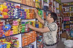 a man is selecting food in a store