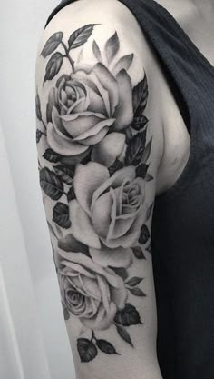 a woman with a black and white rose tattoo on her arm