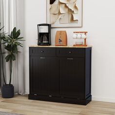 there is a coffee maker on top of the black cabinet in this living room area