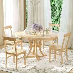 a dining room table with chairs around it