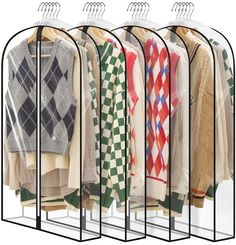 four racks with sweaters hanging on them in front of a white background and one rack holding several sweaters