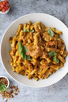 a bowl filled with pasta and sauce on top of a table