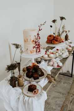 a table topped with cakes and pastries on top of plates